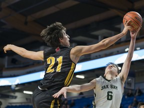 Sasha Vujisic, left, was a tower of power for his Burnaby South Rebels march to the provincial championship title last season and he wants to repeat the feat this year, too. Here he rejected a shot attempt by Oak Bay Bays' Diego Maffia during last year's quarter-final action at Langley Events Centre.