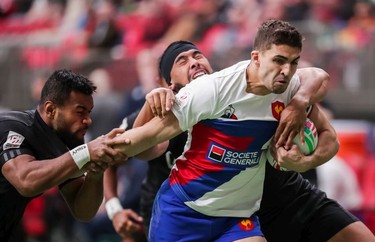 New Zealand's Jona Nareki (11) and Ngarohi McGarvey-Black (10) tackle France's Sadek Deghmache (12) during World Rugby Sevens Series action in Vancouver, B.C., on Saturday March 9, 2019.