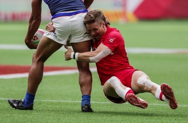 Canada's Luke McCloskey (5) tackles Samoa's Tila Mealoi (9) during World Rugby Sevens Series action in Vancouver, B.C., on Saturday March 9, 2019.