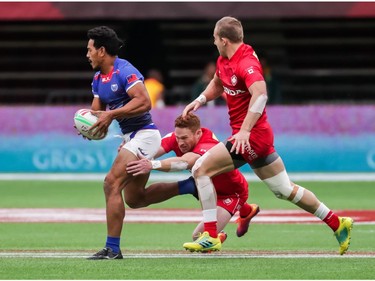 Samoa's Tila Mealoi (9) runs the ball against Canada's Connor Braid (6) and Harry Jones (11) during World Rugby Sevens Series action in Vancouver, B.C., on Saturday March 9, 2019.