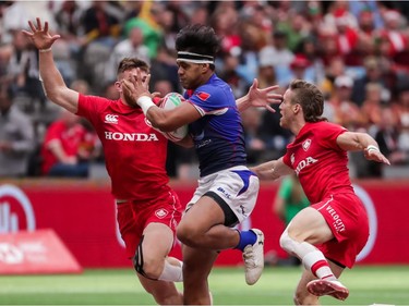 Samoa's Tofatu Solia (1) runs the ball against Canada's Isaac Kaay (8) and Luke McCloskey (5) during World Rugby Sevens Series action in Vancouver, B.C., on Saturday March 9, 2019.
