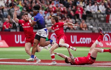 Samoa's Tofatu Solia (1) runs the ball against Canada's Isaac Kaay (8), Luke McCloskey (5) and Connor Braid (6) during World Rugby Sevens Series action in Vancouver, B.C., on Saturday March 9, 2019.
