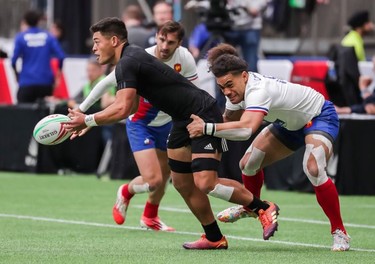 New Zealand's Tone Ng Shiu (3) runs the ball against France's Pierre Gilles Lakafia (8) during World Rugby Sevens Series action in Vancouver, B.C., on Saturday March 9, 2019.