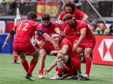 Spain's Joan Losada (9) is surrounded by teammates after their team defeated New Zealand during World Rugby Sevens Series action in Vancouver, B.C., on Saturday, March 9, 2019.