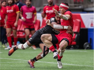 Spain's Joan Losada (9) is tackled by New Zealand's Vilimoni Koroi (6) during World Rugby Sevens Series action in Vancouver, B.C., on Saturday, March 9, 2019.