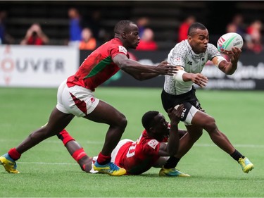 Fiji's Alasio Naduva (10) runs the ball against Kenya's Johnstone Olindi (10) and Daniel Taabu (1) during World Rugby Sevens Series action in Vancouver, B.C., on Saturday March 9, 2019.