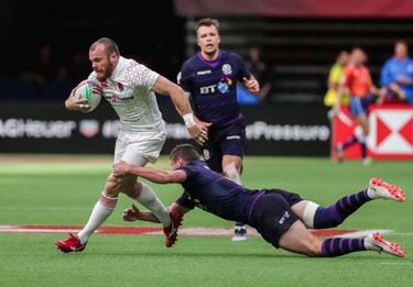 England's Tom Bowen (8) runs the ball against Scotland's Robbie Fergusson (4) during World Rugby Sevens Series action in Vancouver, B.C., on Saturday March 9, 2019.