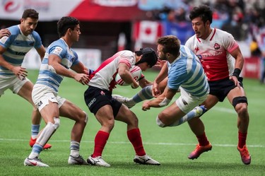 Japan's Kippei Ishida (3) dodges a tackle from Argentina's Fernando Luna (1) during World Rugby Sevens Series action in Vancouver, B.C., on Saturday March 9, 2019.