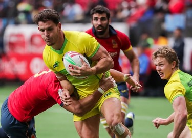 Australia's Simon Kennewell (2) runs the ball against Spain's Javier De Juan (3) during World Rugby Sevens Series action in Vancouver, B.C., on Saturday March 9, 2019.