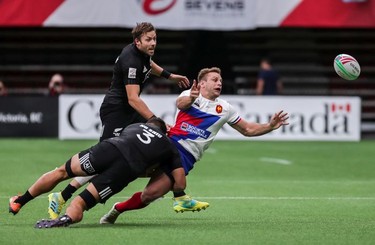 France's Marvin O'Connor (2) is tackled by New Zealand's Tone Ng Shiu (3) during World Rugby Sevens Series action in Vancouver, B.C., on Saturday March 9, 2019.