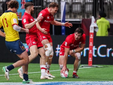 Canada's Matt Mullins scores a try against Spain while teammates Isaac Kaay and Jake Thiel congratulate him during World Rugby Sevens Series action in Vancouver on Sunday, March 10, 2019.