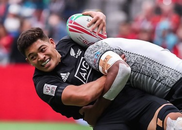 New Zealand's Tone Ng Shiu is tackled by Fiji's Josua Vakurunabili during World Rugby Sevens Series action in Vancouver on Sunday, March 10, 2019.