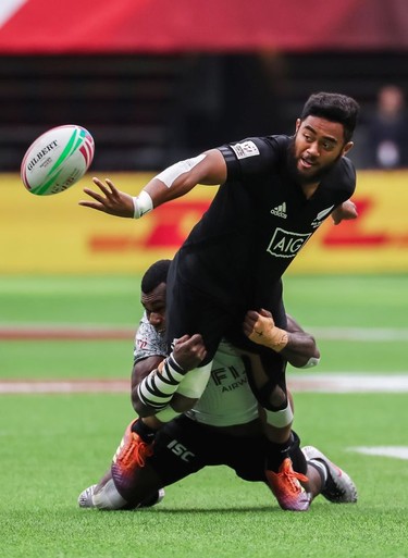 New Zealand's Vilimoni Koroi is tackled by Fiji's Jerry Tuwai, but still manages to offload his pass, during World Rugby Sevens Series action in Vancouver on Sunday, March 10, 2019.