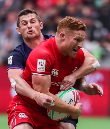 Canada's Connor Braid is tackled by Scotland's Robbie Fergusson during World Rugby Sevens Series action in Vancouver on Sunday, March 10, 2019.