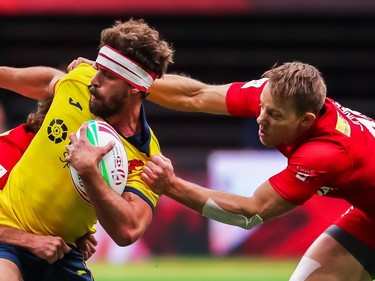 Canada's Harry Jones (right) tackles Spain's Manuel Sainz-Trapaga during World Rugby Sevens Series action in Vancouver on Sunday, March 10, 2019.