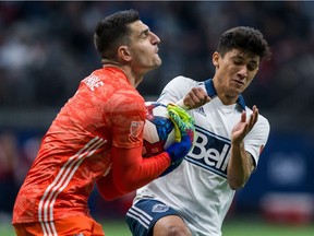 Minnesota United goalkeeper Vito Mannone (1) makes a save near Vancouver Whitecaps' Fredy Montero (12) during second half MLS soccer action in Vancouver on Saturday, March 2, 2019.