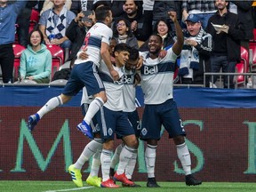 Vancouver Whitecaps' Erik Godoy, centre, celebrates his goal with teammates, from left, Felipe, Fredy Montero and Doneil Henry during the first half of their March 2 season opener against Minnesota United at B.C. Place Stadium.