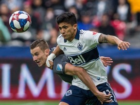 Minnesota United's Jan Gregus (8) plays the ball against Vancouver Whitecaps' Fredy Montero (12) during second half MLS soccer action in Vancouver on Saturday, March 2, 2019.