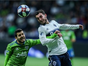 Vancouver Whitecaps' Russell Teibert (31) heads the ball against Seattle Sounders' Victor Rodriguez (8) during the first half MLS soccer action in Vancouver, B.C., on Saturday March 30, 2019.