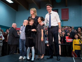 Tamara Taggart hugs her children near Prime Minister Justin Trudeau during a Liberal nomination event in Vancouver, B.C., on Sunday March 24, 2019.