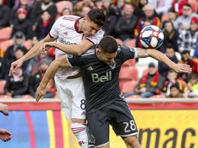 Real Salt Lake midfielder Damir Kreilach (8) heads the ball over Vancouver Whitecaps defender Jake Nerwinski (28) during an MLS soccer match in Sandy, Utah, Saturday, March 9, 2019. Real Salt Lake won, 1-0. (Steve Griffin/The Deseret News via AP) ORG XMIT: UTSAL604