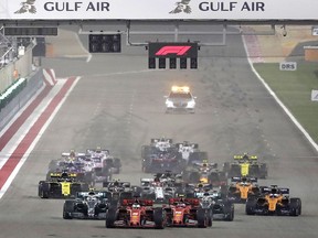 Ferrari driver Charles Leclerc of Monaco, center right, and Ferrari driver Sebastian Vettel of Germany, center left, steer their cars during the start of the Baharain Formula One Grand Prix at the Bahrain International Circuit in Sakhir, Bahrain, Sunday, March 31, 2019.