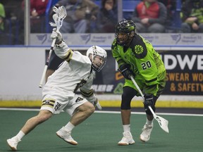 Vancouver Warriors' Colten Porter goes to move the ball past Saskatchewan Rush defender Travis Cornwall during a National Lacrosse League game at SaskTel Centre in Saskatoon on March 30, 2019.