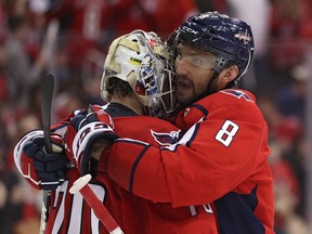 Goalie Braden Holtby of the Washington Capitals celebrates with teammates Alex Ovechkin after defeating the Carolina Hurricanes in Game Five of the Eastern Conference First Round during the 2019 NHL Stanley Cup Playoffs at Capital One Arena on April 20, 2019 in Washington, DC.
