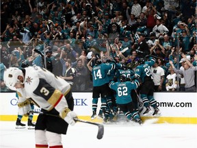 Barclay Goodrow of the San Jose Sharks is congratulated by teammates as Brayden McNabb #3 of the Vegas Golden Knights skates off the ice after he scored the game winning goal in overtime in Game Seven of the Western Conference First Round during the 2019 NHL Stanley Cup Playoffs at SAP Center on April 23, 2019 in San Jose, California.