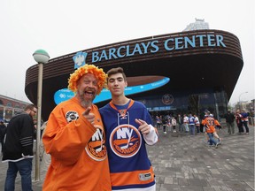 Hockey fans arrive at Barclays Center in Brooklyn for Friday's NHL playoff game between the New York Islanders and the Carolina Hurricanes.