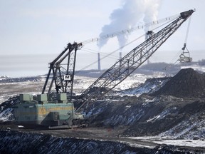 A giant drag line works in the Highvale Coal Mine to feed the nearby Sundance Power Plant near Wabamun, Alberta on Friday, Mar. 21, 2014.