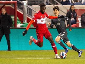 C.J. Sapong of the Chicago Fire manoeuvres past Hwang Inbeom of the Vancouver Whitecaps during Friday's Major League Soccer match at SeatGeek Stadium in Chicago.