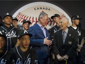 Actor George Takei (middle) chats with former Vancouver Asahi baseball player Kaye in front of the new Canada Post stamp commemorating the team at Burnaby's Nikkei National Museum and Cultural Centre April 24, 2019.