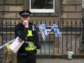 A floral tribute at the scene of the shooting of Trainspotting 2 movie actor Bradley Welsh, in Edinburgh, Scotland, Thursday April 18, 2019. According to a police statement Welsh died at the scene Wednesday, April 17, and their investigations continue. (Jane Barlow/PA via AP)