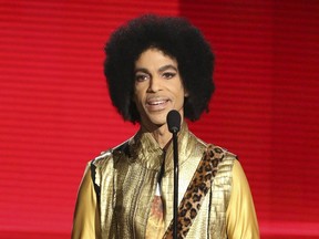 In this Nov. 22, 2015, file photo, Prince presents the award for favourite album - Soul/R&B at the American Music Awards in Los Angeles.