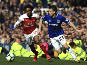 Arsenal's Alex Iwobi (left) and Everton's Seamus Coleman battle for the ball during their English Premier League match at Goodison Park, Liverpool, England, on April 7, 2019.