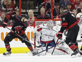 Carolina Hurricanes' Warren Foegele tries to score against Washington Capitals goalie Braden Holtby while Hurricanes' Jordan Staal assists during the first period of Game 6 of an NHL first-round playoff series in Raleigh, N.C., Monday, April 22, 2019.