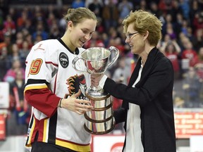 In this May 13, 2016, file photo, Canadian Women's Hockey League commissioner Brenda Andress, right, presents Calgary Inferno captain Brianne Jenner with the Clarkson Cup trophy after Calgary defeated Les Canadiennes de Montreal in Ottawa. The woman who ran the Canadian Women's Hockey League for 11 years says she???s saddened by the announcement it will fold, but Andress says she does not know what transpired since she stepped down a year ago to bring about the league???s demise.