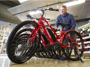 Tom Richards, a sales assistant at Bicycle Sports Pacific in Vancouver, shows off some new Trek electric bikes.