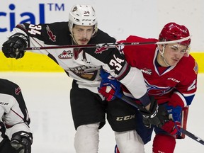 Vancouver Giants Brayden Watts tangles with Spokane Chiefs Luke Toporowski in Game 2 of the Western Hockey League Western Conference finals at the Langley Events Centre on Saturday. Photo: Gerry Kahrmann/Postmedia