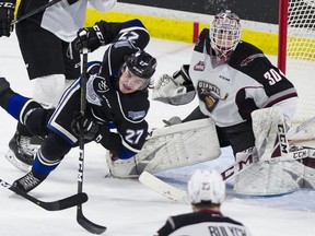 Victoria Royals Phillip Schultz crashes in front of Vancouver Giants goalie Davis Tendeck in the second period of the Giants' 2-1 overtime win over the Royals on Saturday. Gerry Kahrmann/PNG