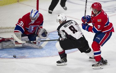 Spokane Chief Nolan Reid watches as goalie Bailey Brkin stops a shot from Vancouver Giant Tristen Nielsen in Game 5 of the WHL Western Conference Championship in Langley April 26, 2019.