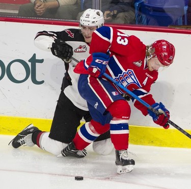 Spokane Chief Riley Woods looks for the puck after knocking Vancouver Giant Davis Koch to his knees in Game 5 of the WHL Western Conference Championship in Langley April 26, 2019.