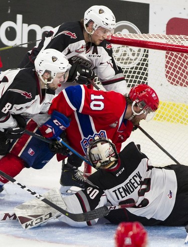 Vancouver Giants Dylan Pouffe and Tristen Nielsen try to clear Spokane Chief Ethan McIndoe as he drives to the net beside Giants goalie Davis Tendeck in Game 5 of the WHL Western Conference Championship in Langley April 26, 2019.