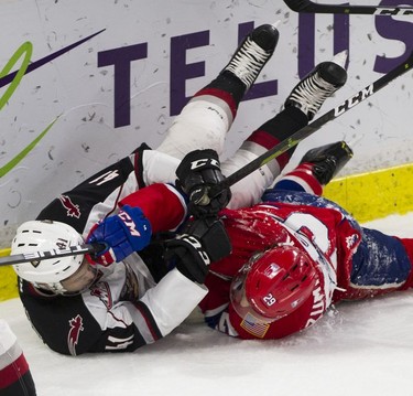 Vancouver Giant Alex Kannok Leipert gets tangled up with Spokane Chief Eli Zummackr in Game 5 of the WHL Western Conference Championship in Langley April 26, 2019.