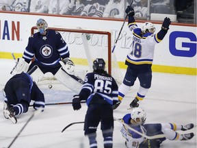 Winnipeg Jets goaltender Connor Hellebuyck (37) reacts after missing the game winning shot by St. Louis Blues' Tyler Bozak (21) during third period NHL playoff action in Winnipeg on Wednesday, April 10, 2019.