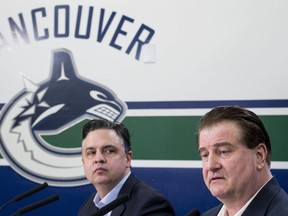 Vancouver Canucks general manager Jim Benning, right, and head coach Travis Green pause for a moment during a news conference at Rogers Arena in Vancouver on Monday, April 8, 2019. The Canucks finished their season this past weekend failing to make the 2019 playoffs.