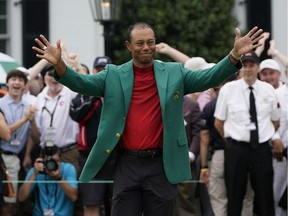 Tiger Woods acknowledges the crowd after donning the winner's green jacket for capturing the Masters golf tournament on Sunday, April 14, 2019 in Augusta, Ga.