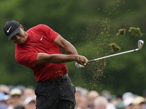 Tiger Woods hits on the 12th hole during the final round for the Masters golf tournament, Sunday, April 14, 2019, in Augusta, Ga.