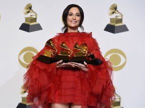 FILE - In this Feb. 10, 2019 file photo, Kacey Musgraves, winner of the awards for best country album for "Golden Hour", best country song for "Space Cowboy", best country solo performance for "Butterflies" and album of the year for "Golden Hour" poses in the press room at the 61st annual Grammy Awards at the Staples Center in Los Angeles. Musgraves made history when she won the 2019 Grammy for album of the year, but there's one award she won't win: entertainer of the year at the Academy of Country Music Awards. That's because no women are nominated for the show's top award Sunday, April 7. Instead, men make up the nominees exclusively with Chris Stapleton, Keith Urban, Kenny Chesney, Luke Bryan and Jason Aldean.